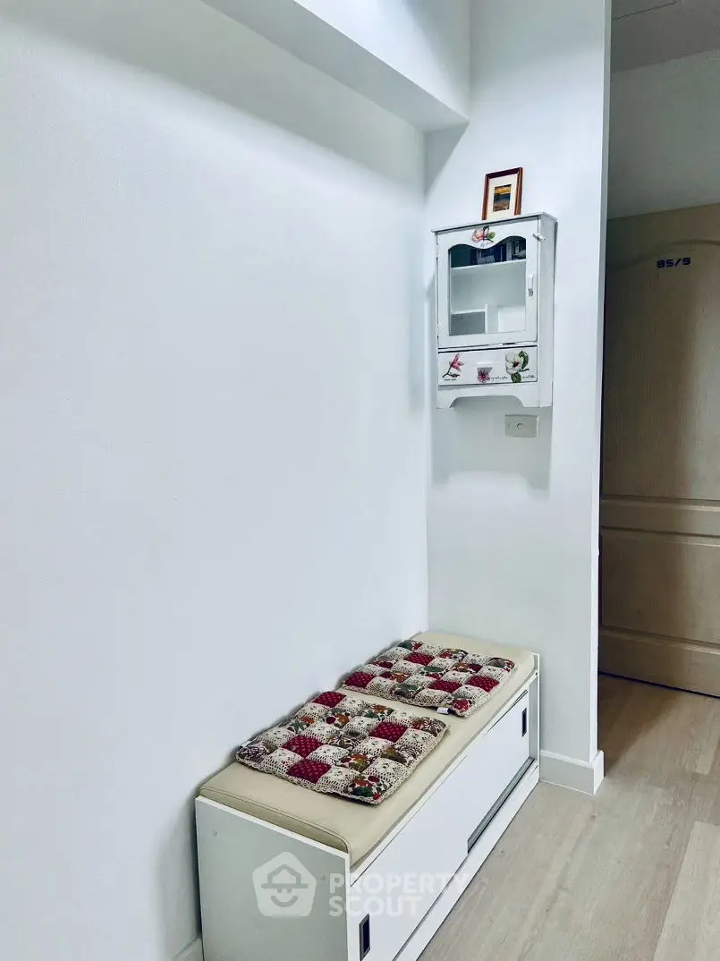 Cozy hallway with bench and wall-mounted cabinet, perfect for small spaces.