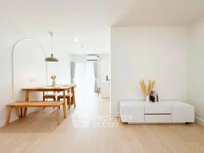 Modern minimalist living room with natural light and wooden furniture