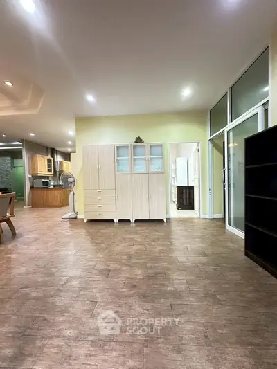 Spacious open-plan living area with modern kitchen and ample storage.