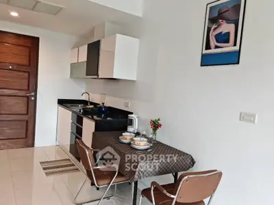 Chic modern kitchen with dining area, sleek cabinetry, and stylish decor.