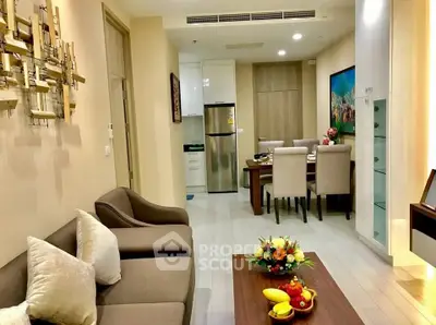 Modern living room with elegant dining area and stylish kitchen in open layout apartment.