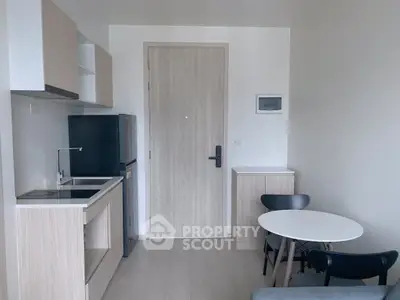 Modern compact kitchen with dining area in a stylish apartment