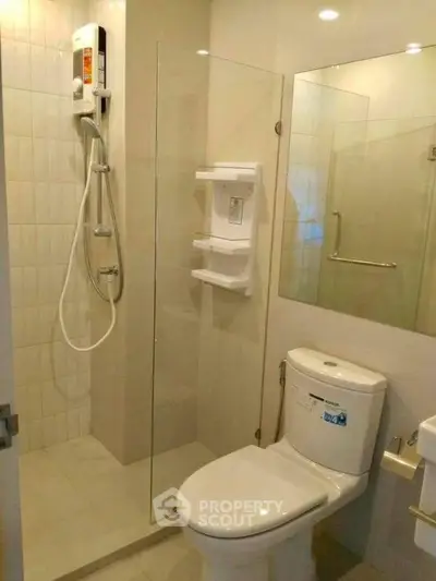 Modern bathroom with glass shower enclosure and sleek fixtures