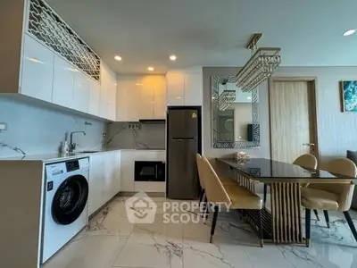 Modern kitchen with sleek appliances and elegant dining area