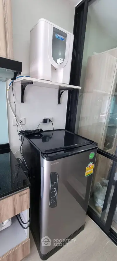 Modern kitchen corner with sleek fridge and water purifier setup