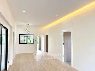 Spacious modern living room with elegant lighting and wooden flooring