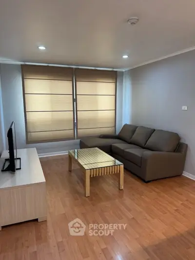 Modern living room with sleek furniture and wooden flooring