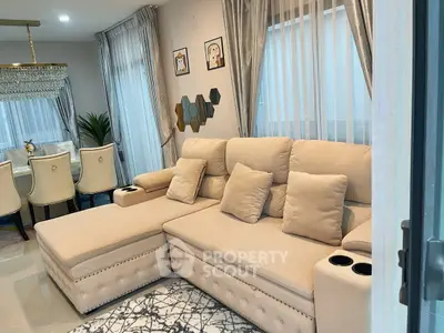 Luxurious living room with plush beige sofa and elegant dining area