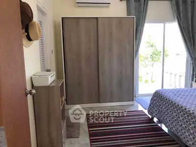 Cozy bedroom with sliding wardrobe and balcony access, perfect for relaxation and comfort.