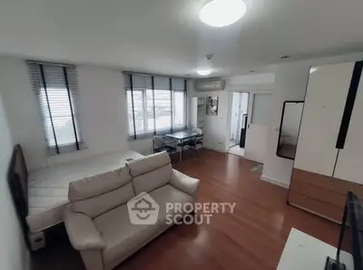 Modern living room with wooden flooring and stylish furniture in a bright apartment.