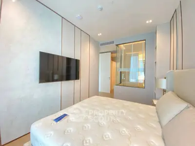 Luxurious modern bedroom with elegant decor and wall-mounted TV