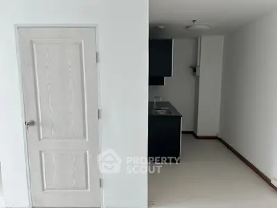 Minimalist kitchen with sleek cabinetry and modern sink in compact space