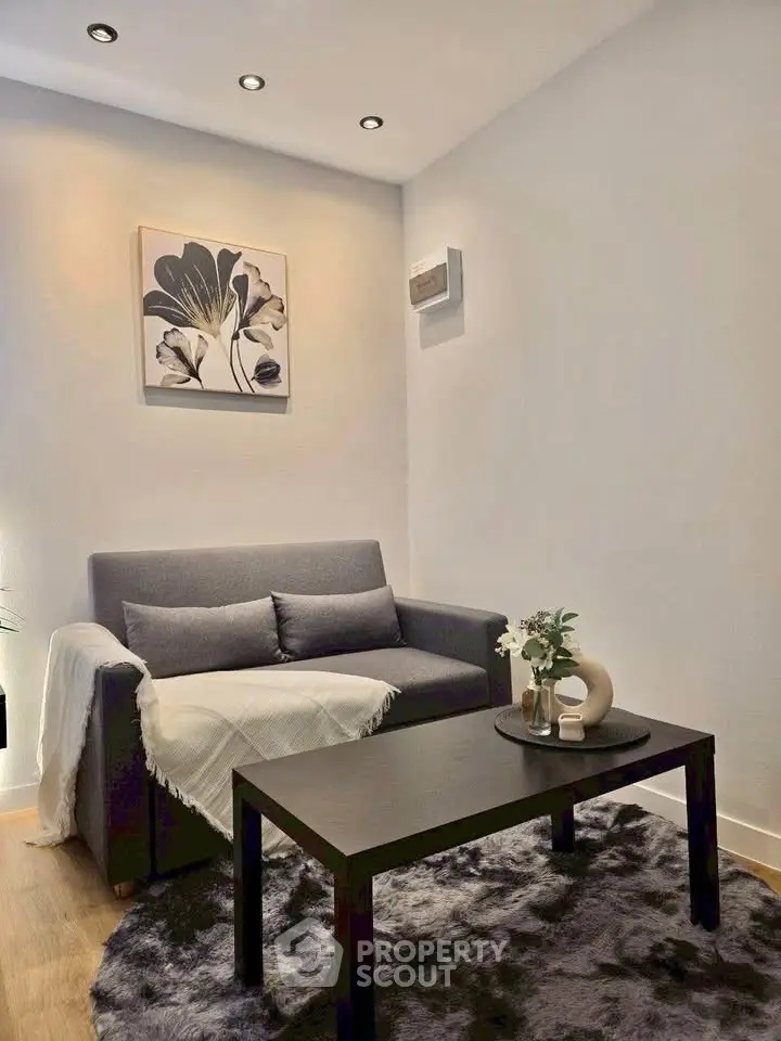 Cozy living room with modern decor and comfortable seating in a stylish apartment.