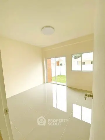Bright empty room with large window and glossy tiled floor