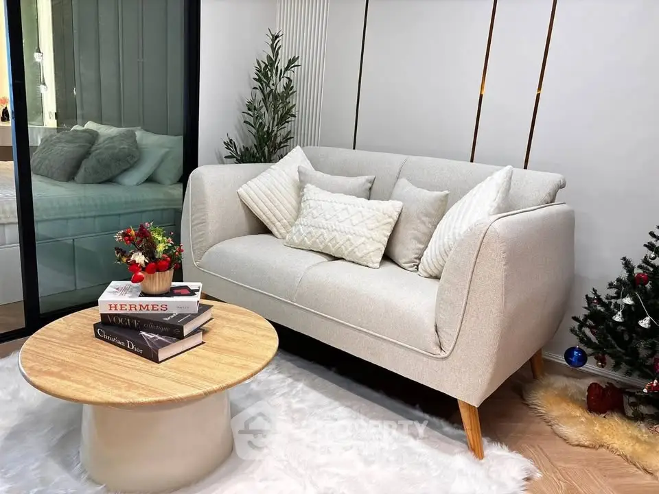 Cozy living room with elegant sofa, stylish coffee table, and festive decor, perfect for modern living.