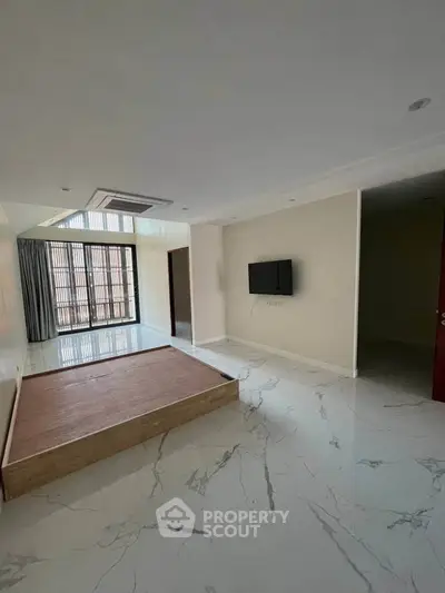 Spacious modern living room with marble flooring and large windows