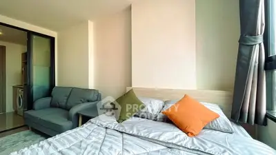 Modern bedroom with cozy sofa and large window for natural light