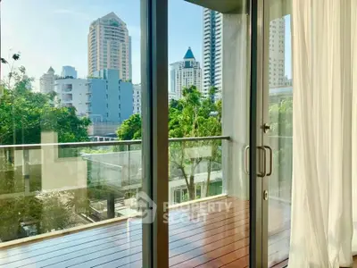 Spacious balcony with stunning city view and modern glass doors