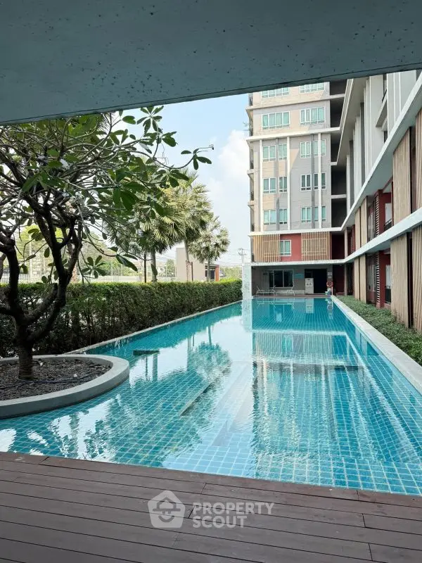 Luxurious apartment complex with stunning outdoor pool and lush greenery
