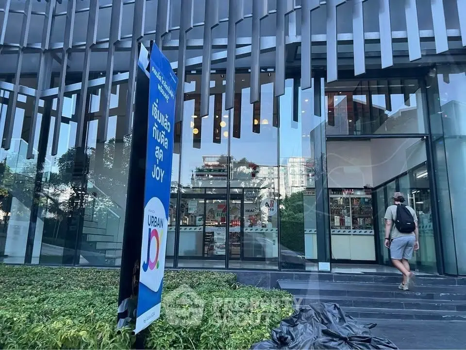 Modern building entrance with glass facade and urban design elements.