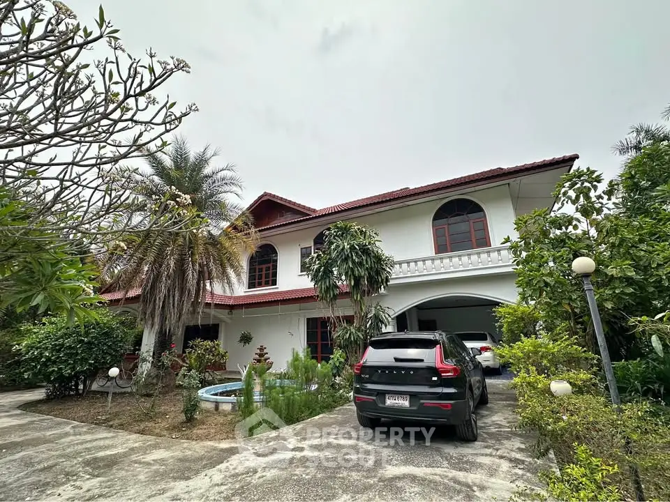 Charming two-story house with lush garden and driveway parking