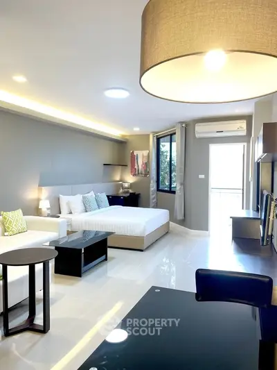 Modern and spacious bedroom with stylish decor and ample natural light.