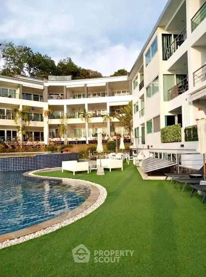 Luxurious apartment complex with stunning pool and lush greenery
