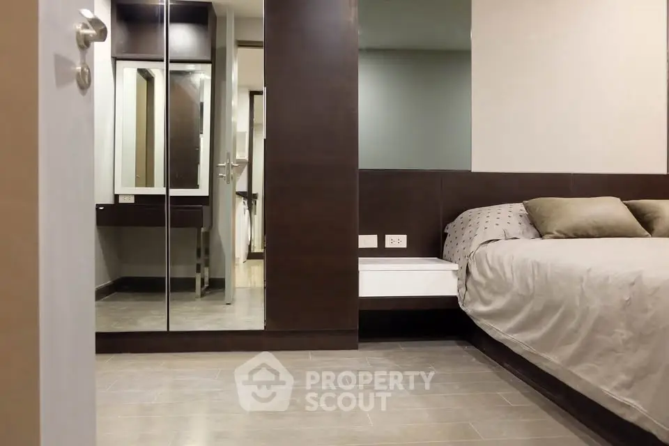 Modern bedroom with mirrored wardrobe and sleek design