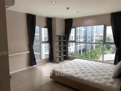 Spacious corner bedroom with large windows and city view in modern apartment