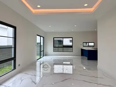 Spacious modern living room with marble flooring and recessed lighting