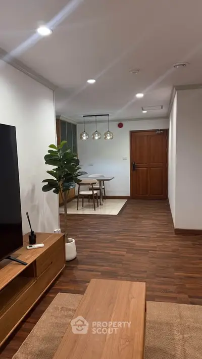 Modern living room with wooden flooring and stylish dining area