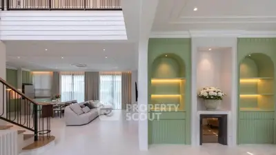 Luxurious open-plan living room with elegant staircase and modern decor