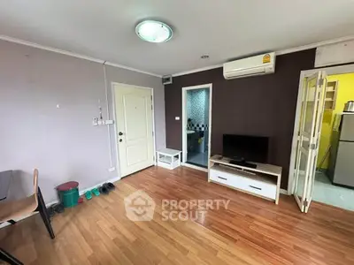 Cozy living room with wooden flooring, air conditioning, and modern furniture in a stylish apartment.