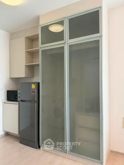 Modern kitchen with sleek cabinetry and appliances in a stylish apartment.
