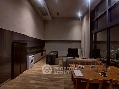 Luxurious open-plan living room with modern kitchen and city view.