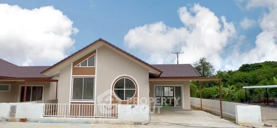 Charming single-story house with modern design and spacious driveway, perfect for family living.