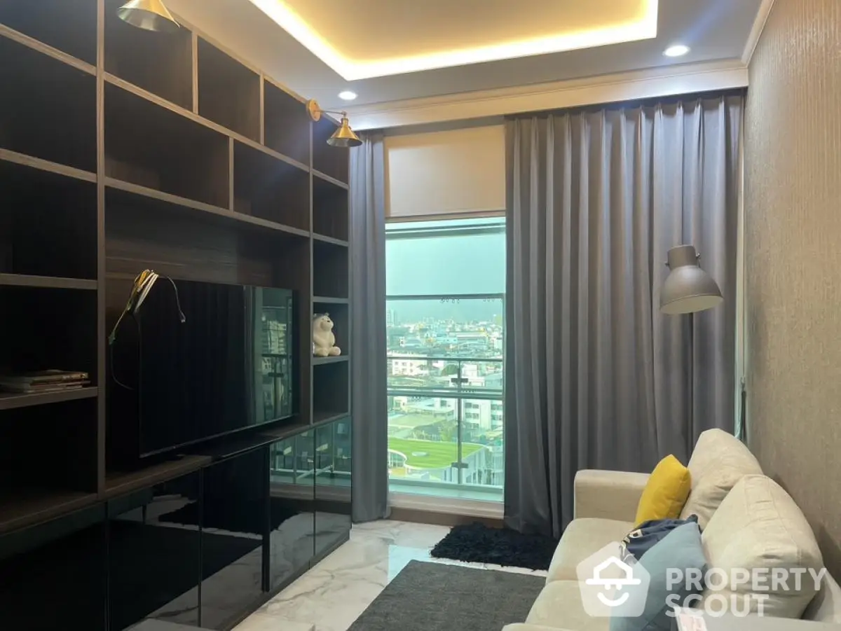 Modern living room with city view, sleek shelving, and cozy seating area.