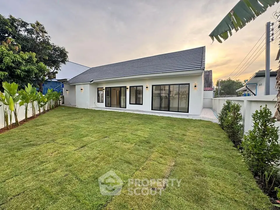 Charming single-story home with lush green lawn and modern design, perfect for family living.