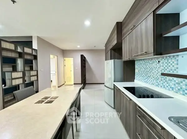 Modern kitchen with sleek cabinetry and dining area in open layout