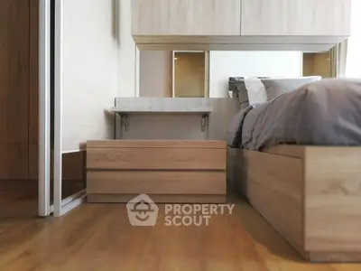 Modern bedroom with wooden flooring and sleek furniture design