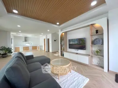 Spacious modern living room with elegant decor and open kitchen layout