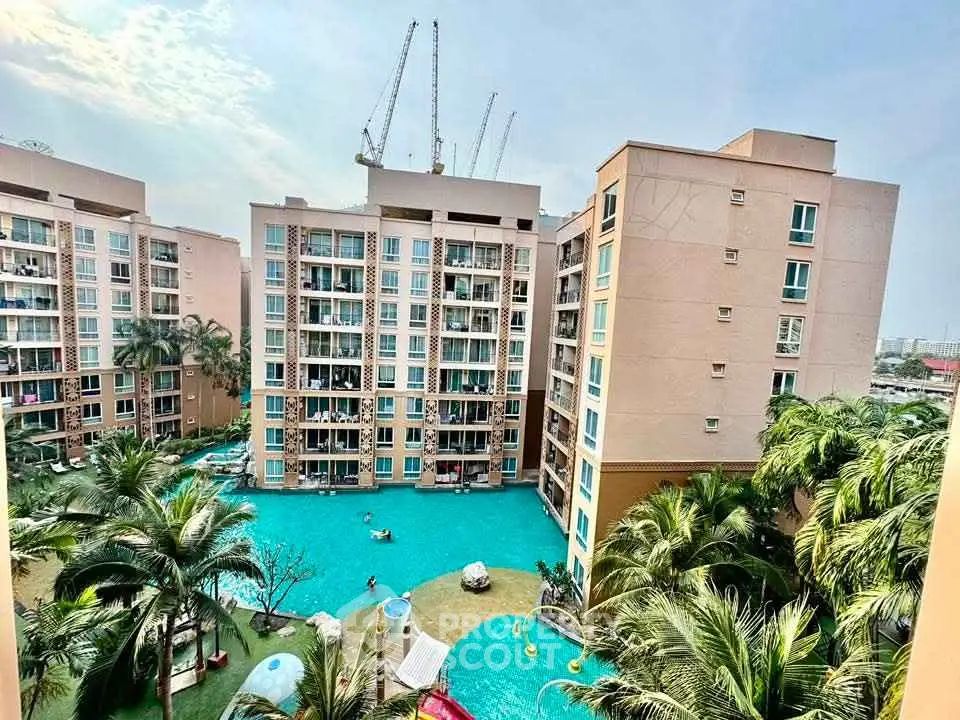 Luxurious apartment complex with stunning pool and lush greenery view.