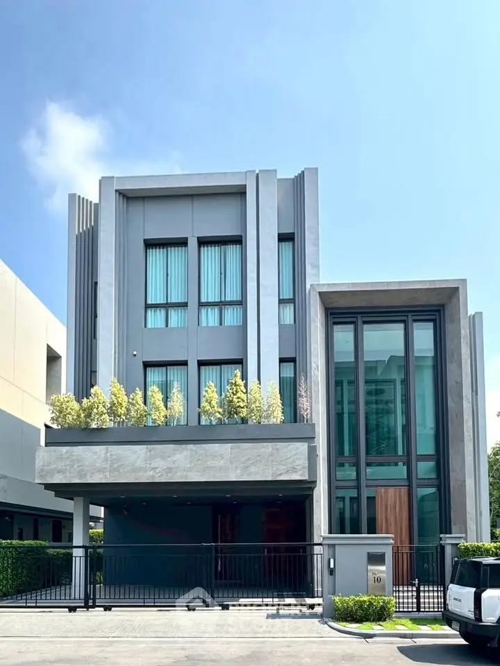 Modern luxury home with sleek architecture and lush greenery in a prestigious neighborhood.