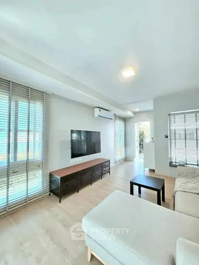 Spacious modern living room with large windows and stylish furniture