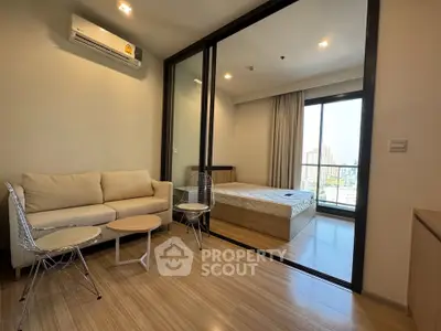 Modern apartment interior with cozy living room and bedroom, featuring wooden flooring and city view.