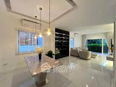 Luxurious open-plan living room with modern decor and elegant lighting