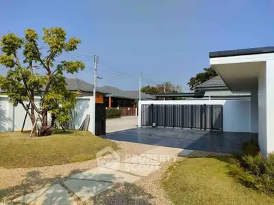 Modern home entrance with sleek gate and landscaped garden