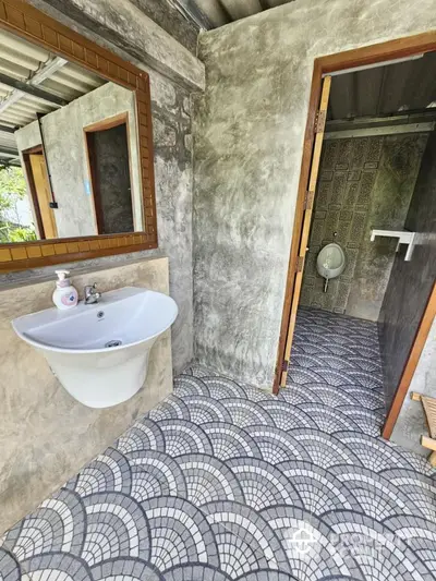 Charming rustic bathroom with unique tile flooring and modern fixtures