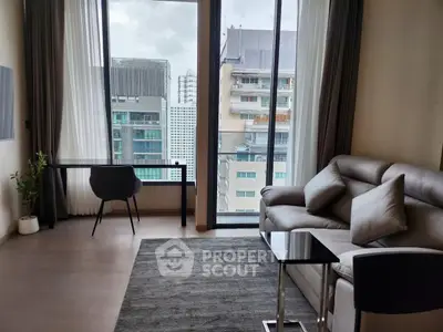 Modern living room with city view, stylish furniture, and large windows in urban apartment.