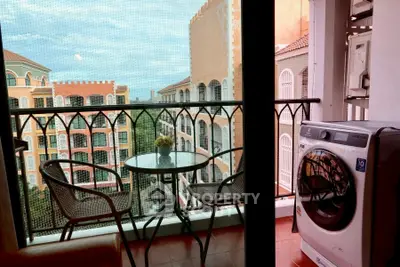 Charming balcony with washing machine and scenic view of Mediterranean-style buildings.